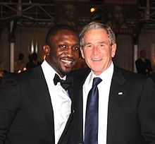 Darey with former U.S. President George W. Bush while hosting the ThisDay Awards in Abuja, Nigeria | Wikipedia